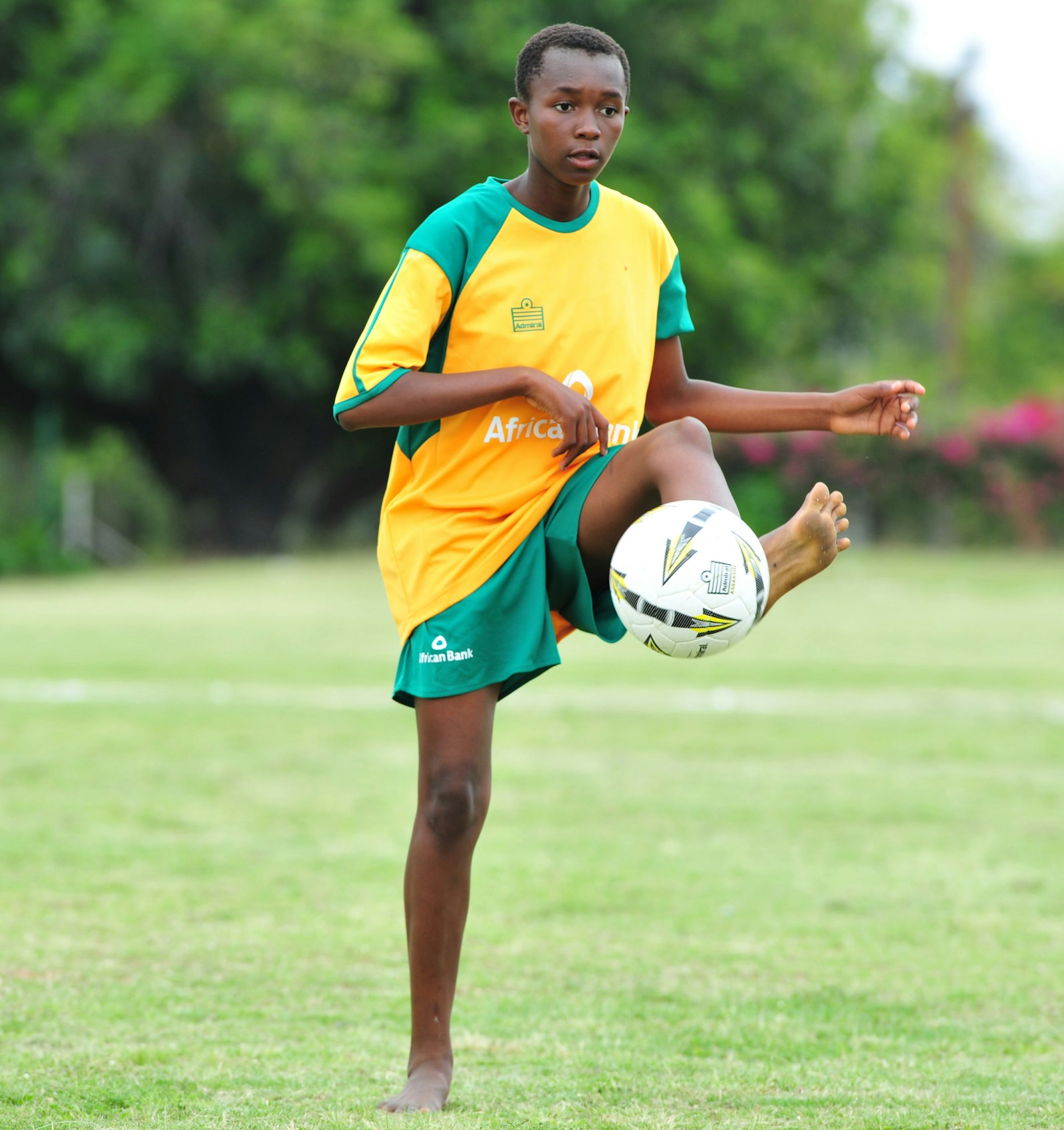 A young footballer practising with a ball